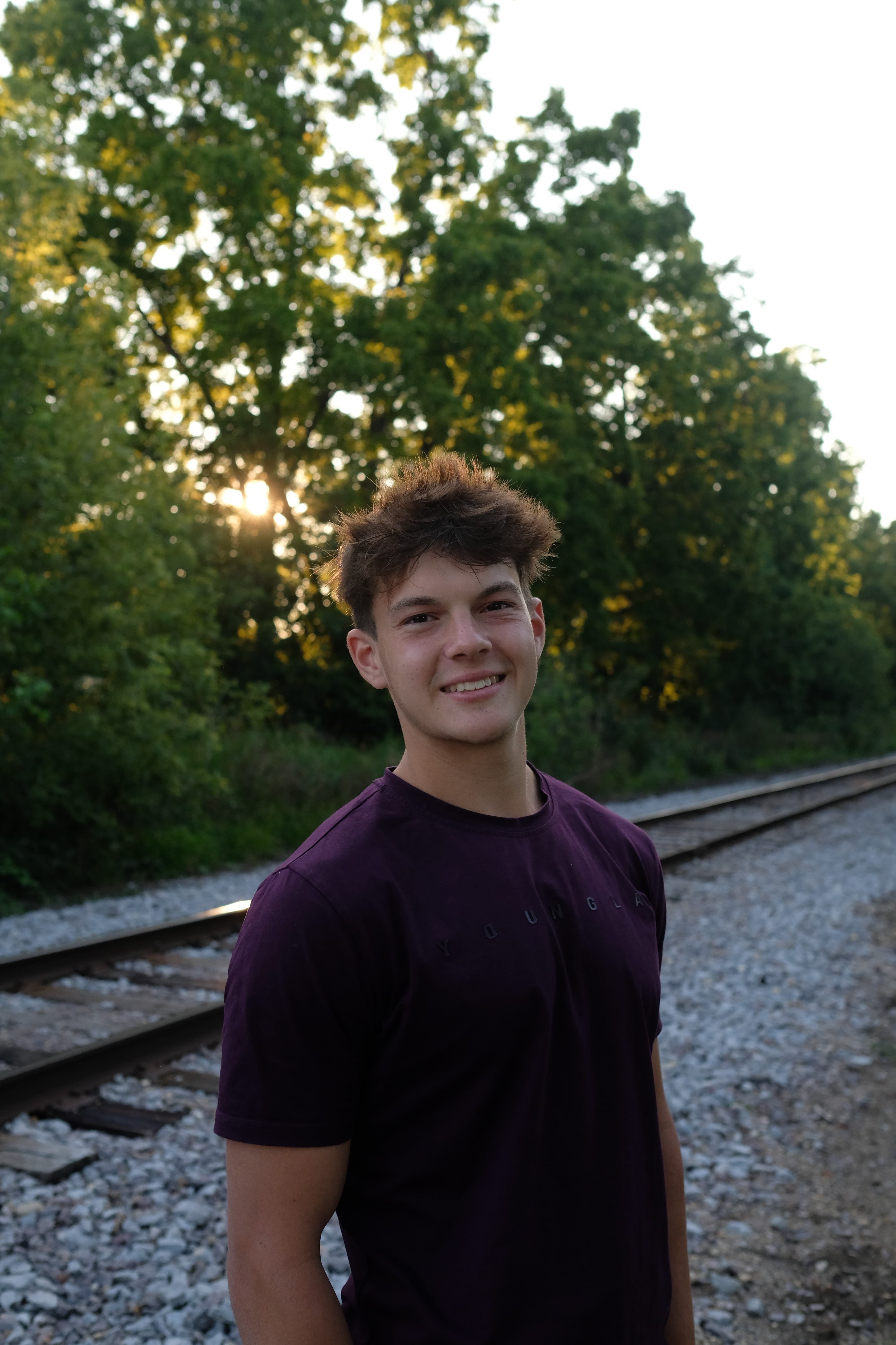 Elliot, founder of Silicon From Scratch, standing outdoors beside a railway.